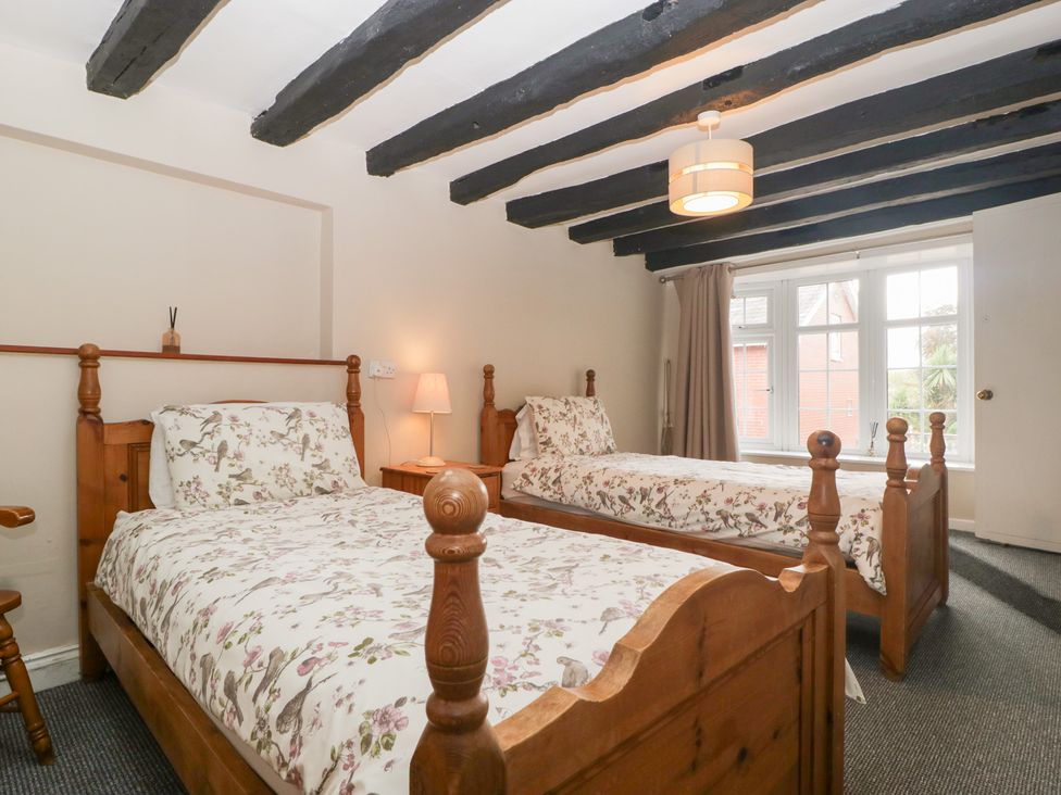 A bedroom with two single beds and a window at The Croft in Vowchurch near Peterchurch