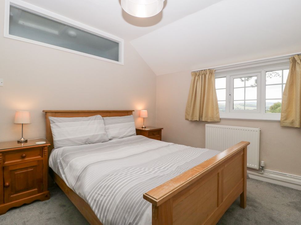 A bedroom with a bed and nightstand at The Croft in Vowchurch near Peterchurch
