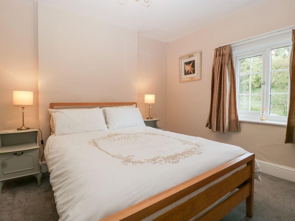 A bedroom with a bed and nightstand at The Croft in Vowchurch near Peterchurch