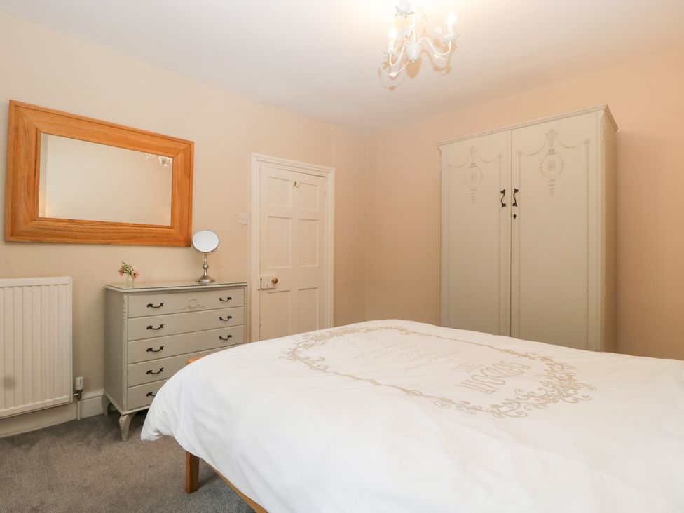 A bedroom with a bed and wardrobe at The Croft in Vowchurch near Peterchurch