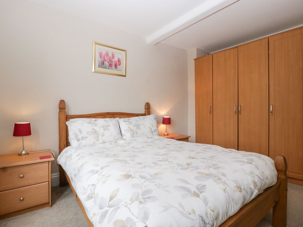 A bedroom with a bed and wardrobe at The Croft in Vowchurch near Peterchurch