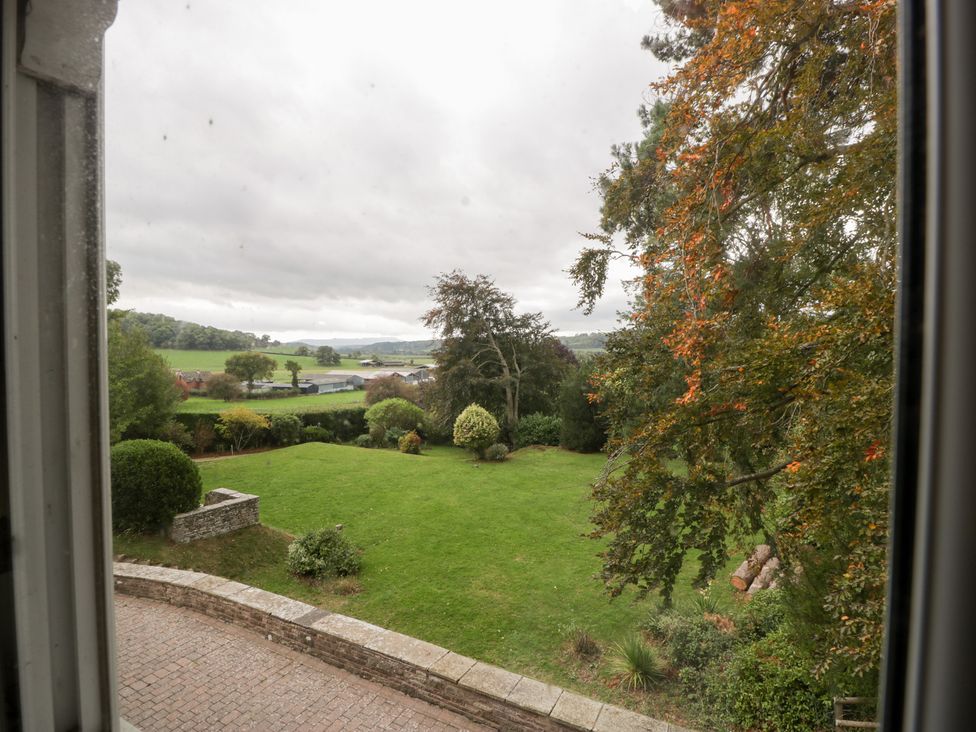 A view of a garden with trees and lawn at The Croft in Vowchurch near Peterchurch