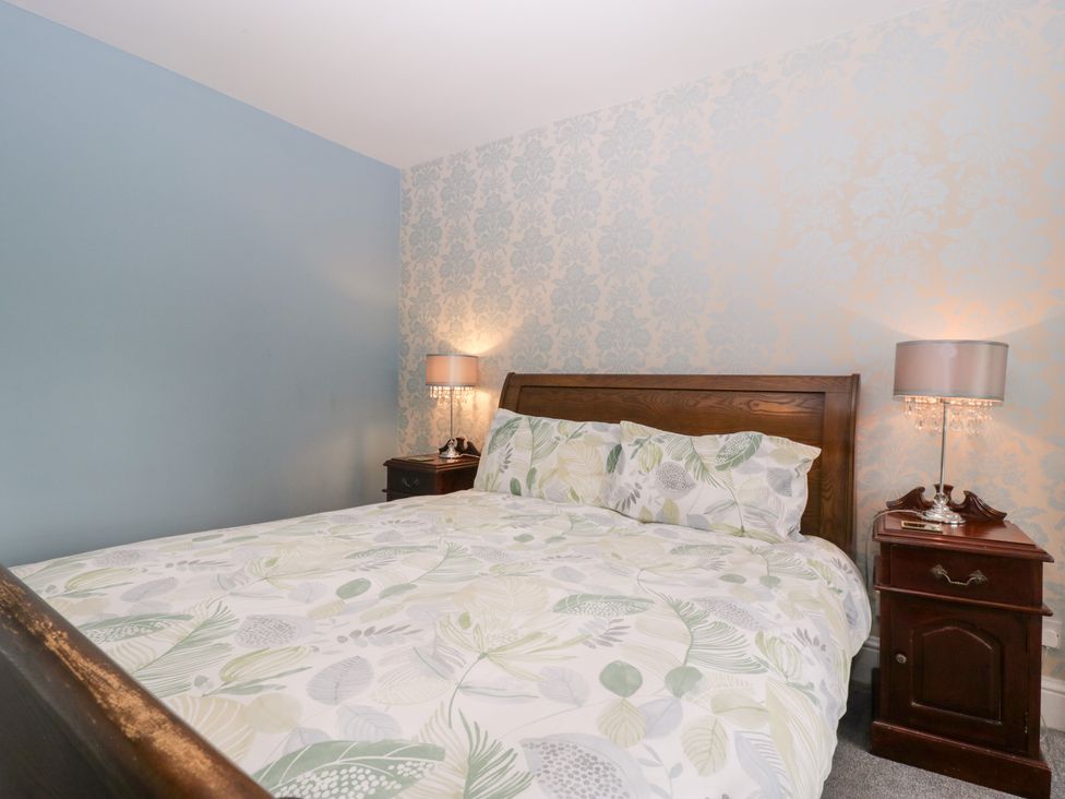 A bedroom with a bed and nightstand at The Croft in Vowchurch near Peterchurch
