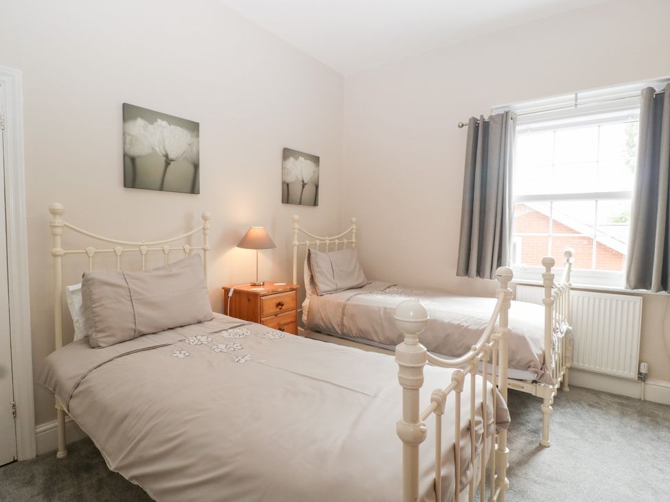 A bedroom with two beds and a bedside table at The Croft in Vowchurch near Peterchurch