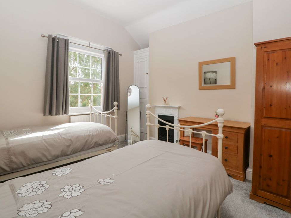 A bedroom with two beds and a window at The Croft in Vowchurch near Peterchurch