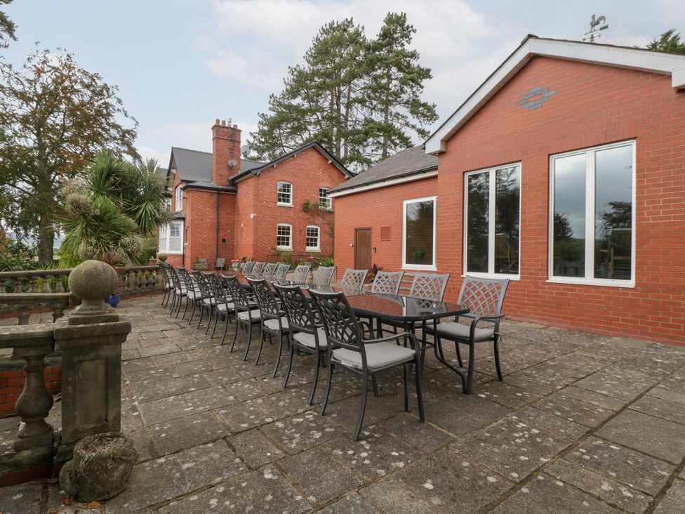 An outdoor patio with a large table and chairs at The Croft in Vowchurch near Peterchurch