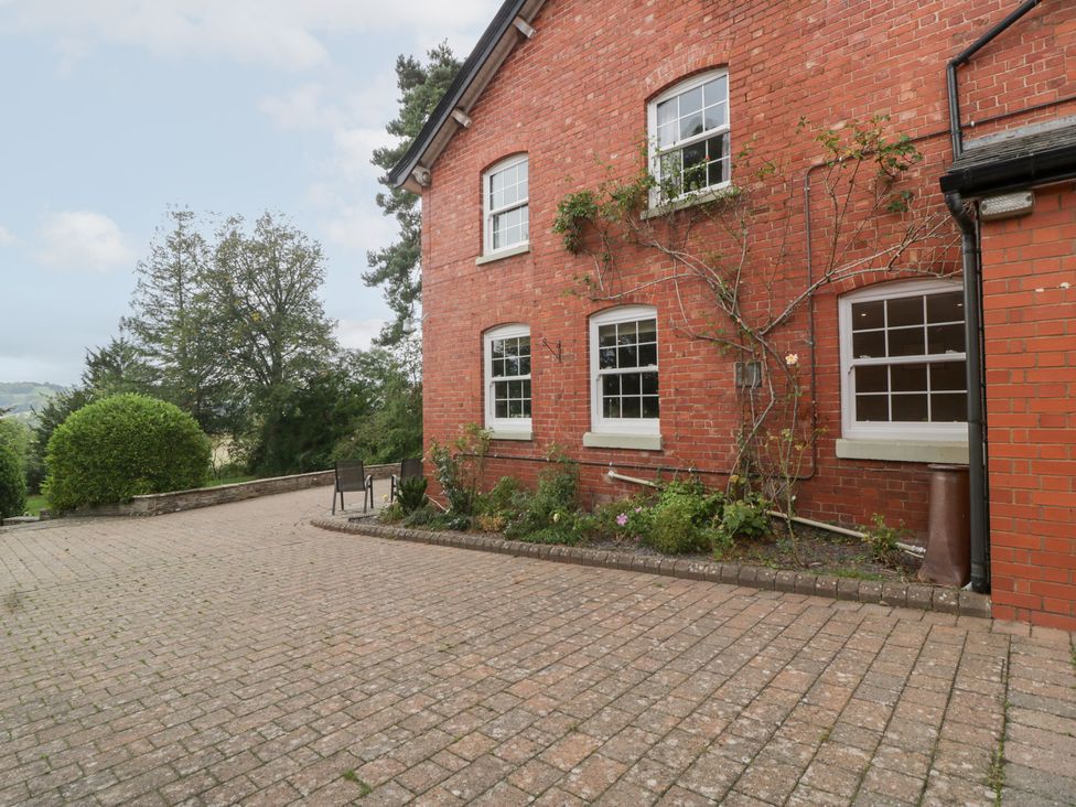 An outdoor area with brick walls and windows at The Croft in Vowchurch near Peterchurch