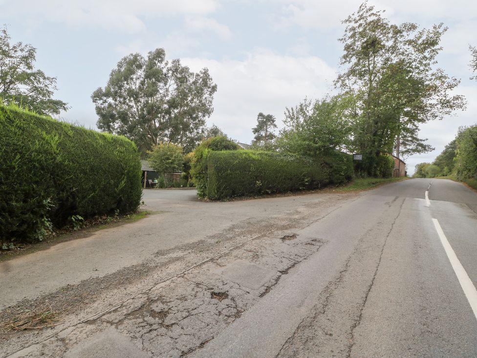 A street view with hedges and trees at The Croft in Vowchurch near Peterchurch
