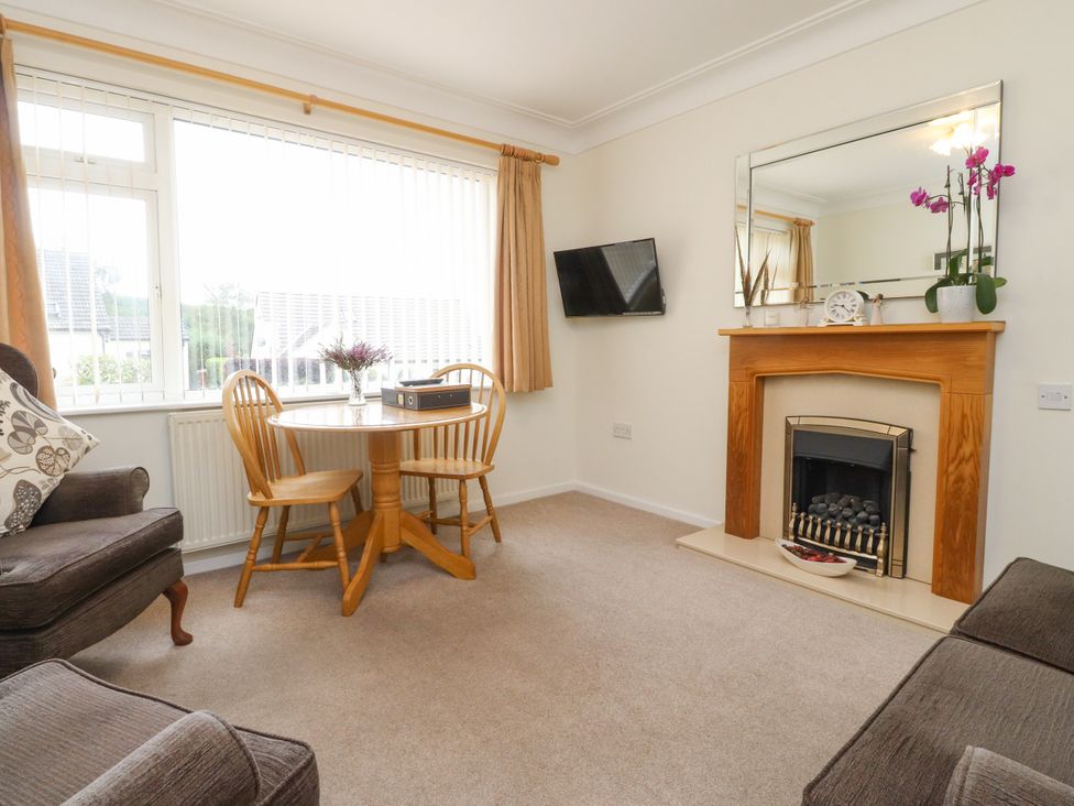 A living room with a sofa and dining table at Wynnville in Embsay near Skipton