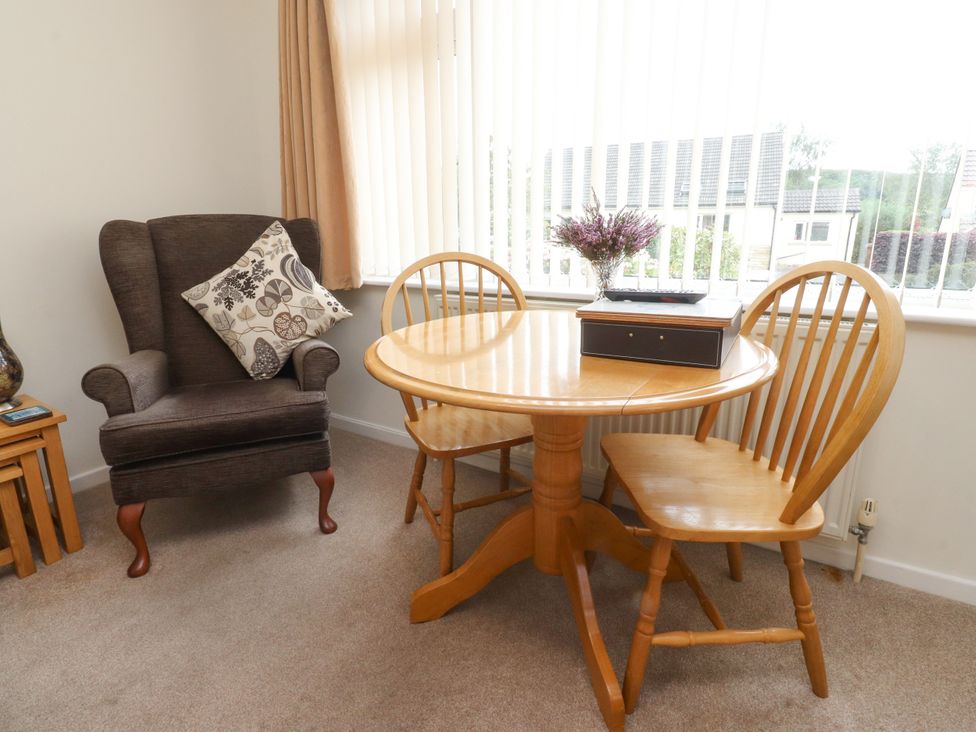 A dining room with a table and chairs at Wynnville Embsay near Skipton