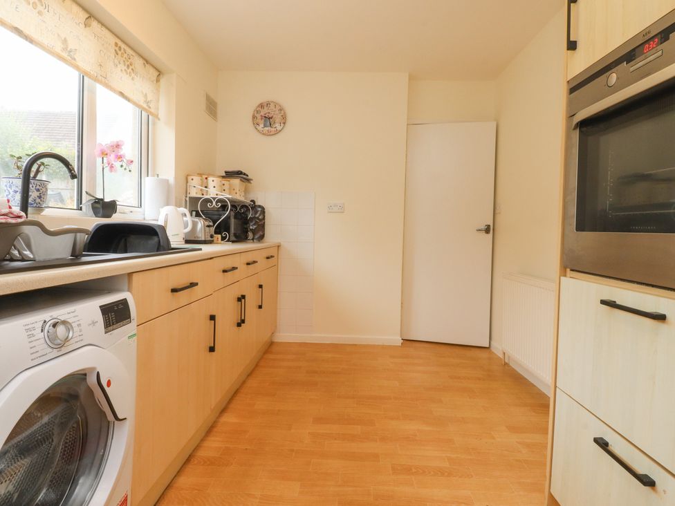 A kitchen with a washing machine and sink at Wynnville in Embsay near Skipton