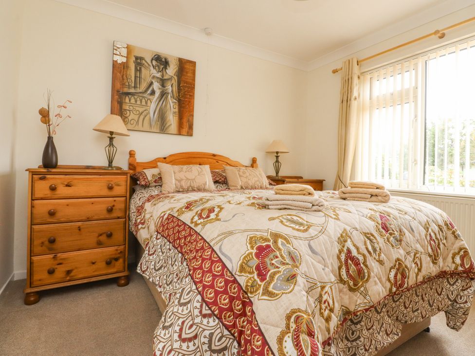 A bedroom with a bed and dresser at Wynnville in Embsay near Skipton