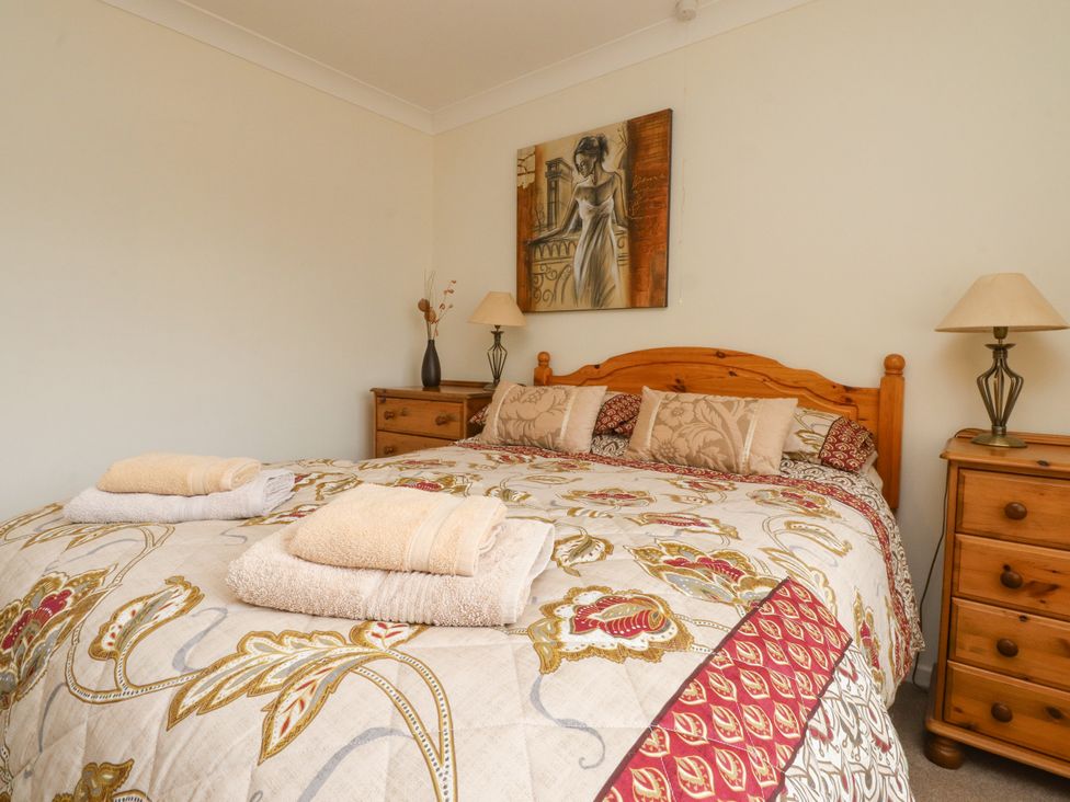 A bedroom with a bed and bedside tables at Wynnville in Embsay near Skipton