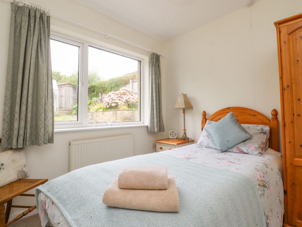 A bedroom with a bed and window at Wynnville in Embsay near Skipton