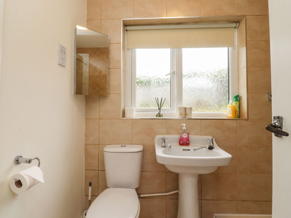 A bathroom with a toilet and sink at Wynnville in Embsay near Skipton