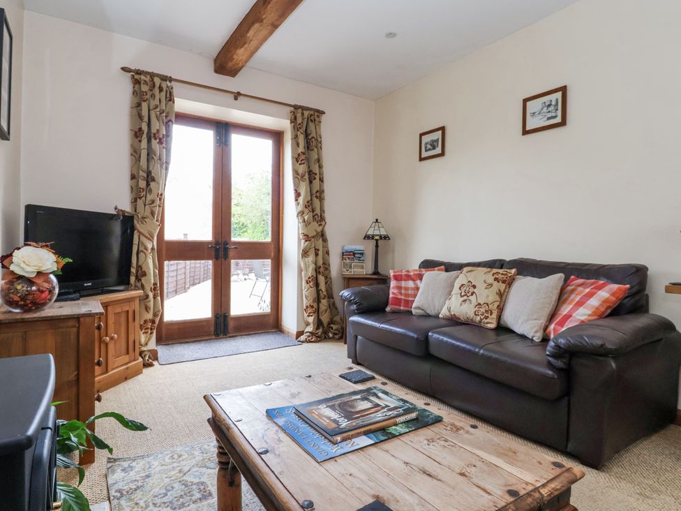 A living room with a sofa and television at Croft Granary in Stillington near Easingwold and York