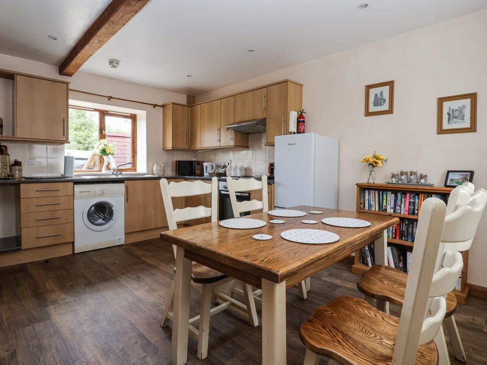 A kitchen with a table and chairs at Croft Granary in Stillington near Easingwold and York