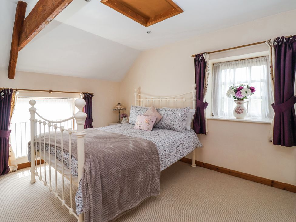 A bedroom with a bed and a window at Croft Granary in Stillington near Easingwold and York
