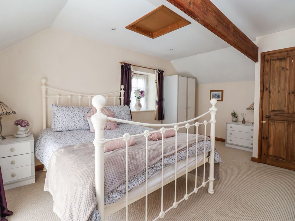 A bedroom with a bed and wardrobe at Croft Granary in Stillington near Easingwold and York