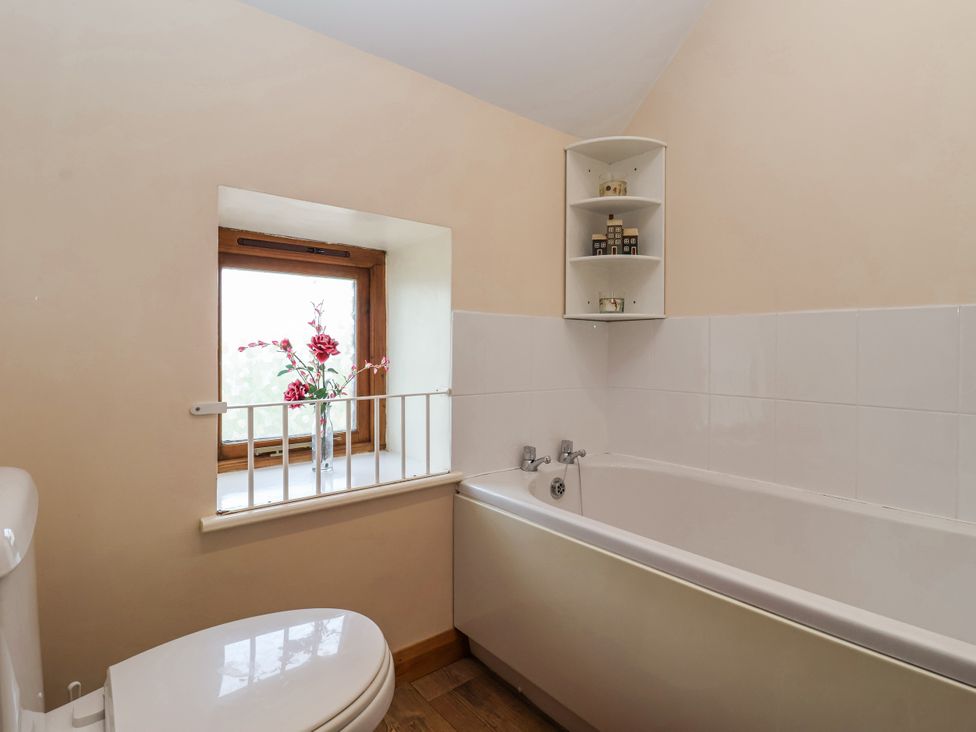 A bathroom with a bathtub and a window at Croft Granary Stillington near Easingwold and York