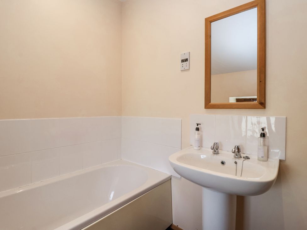 A bathroom with a bathtub and sink at Croft Granary in Stillington near Easingwold and York