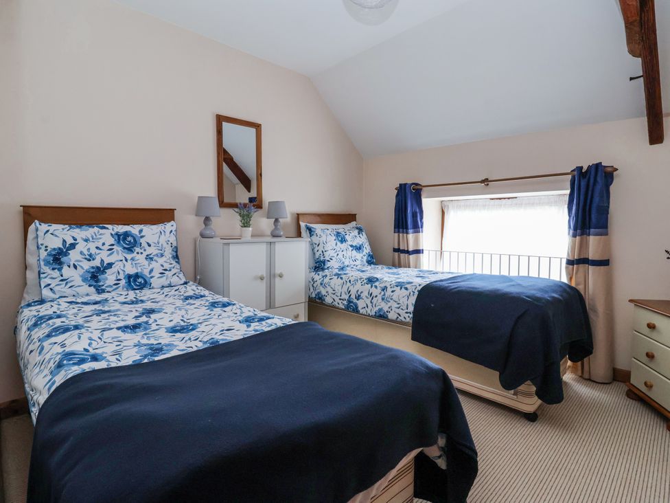 A bedroom with two beds and a nightstand at Croft Granary Stillington near Easingwold and York