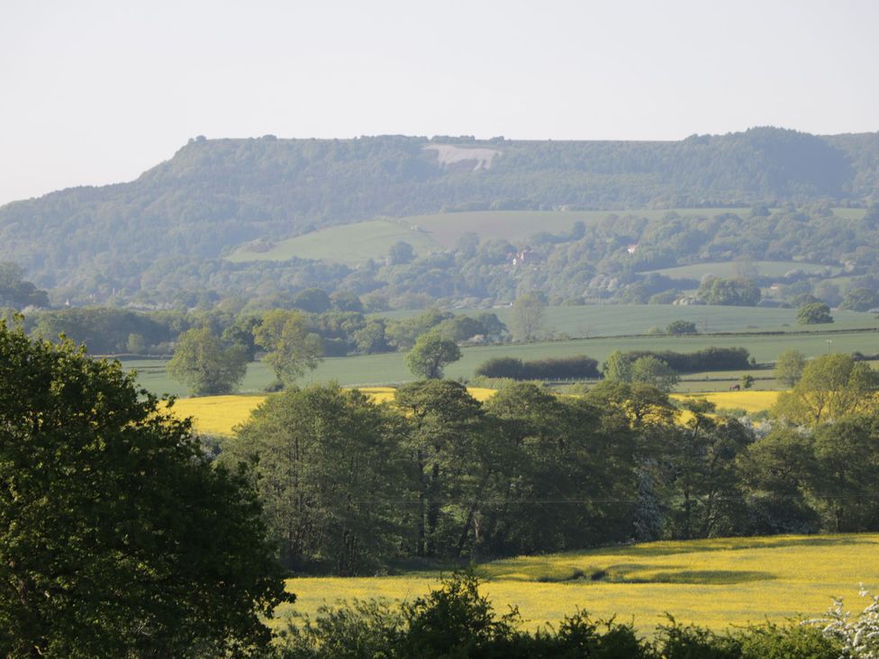 A view of hills and fields with trees in the foreground at Croft Granary in Stillington near Easingwold and York