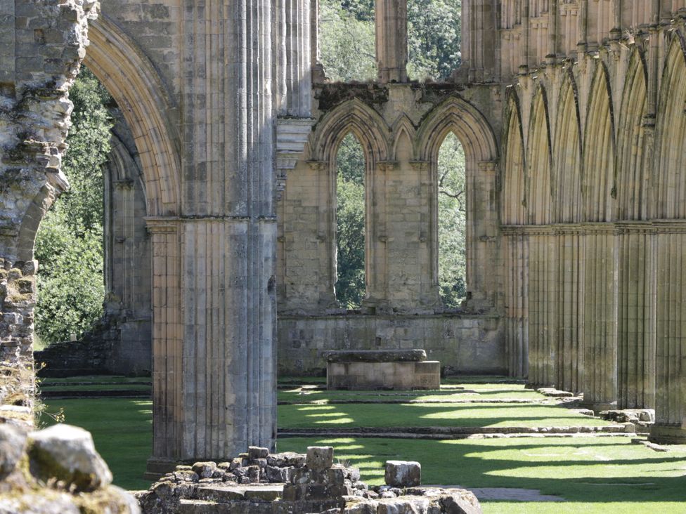 An interior view of an old stone structure with columns and arches at Croft Granary in Stillington near Easingwold and York