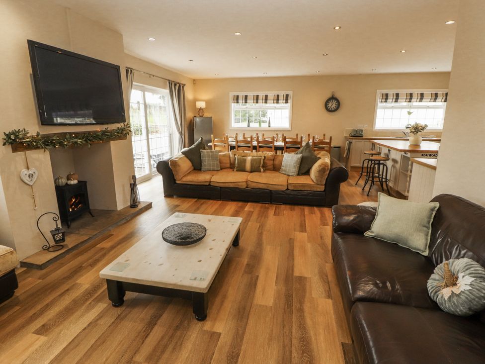 A living room with a sofa and coffee table at White Gables in Great Clifton near Cockermouth