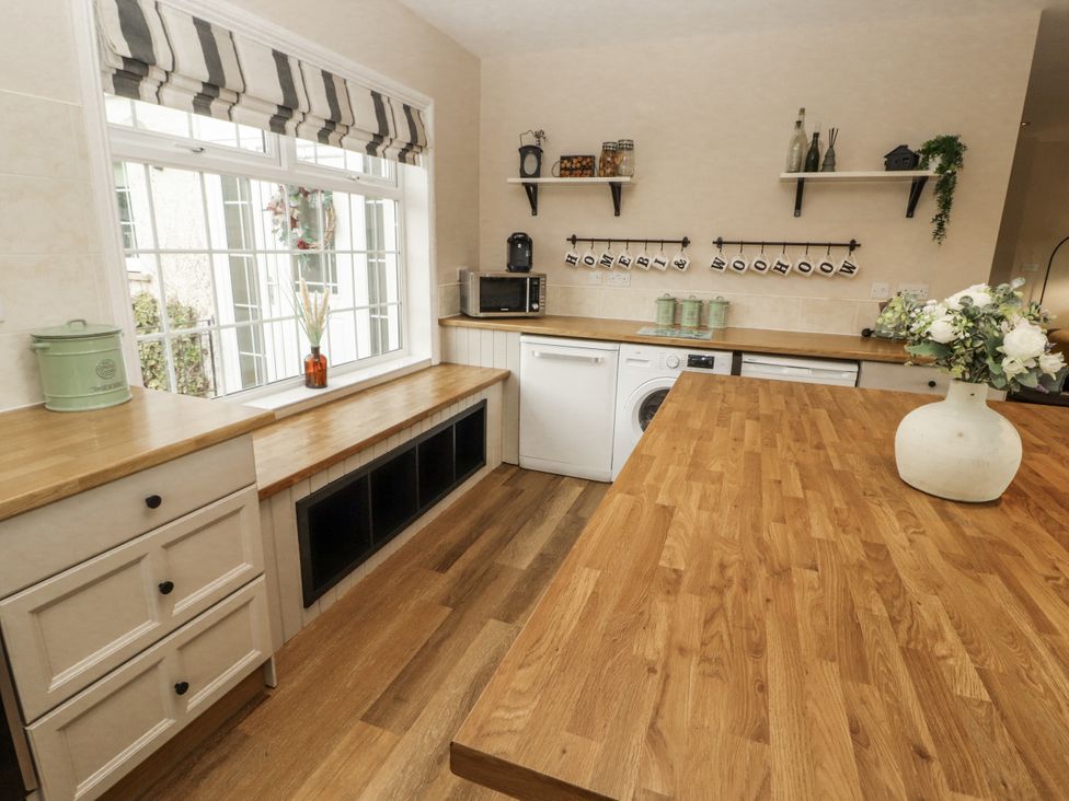 A kitchen with cabinets and appliances at White Gables Great Clifton near Cockermouth