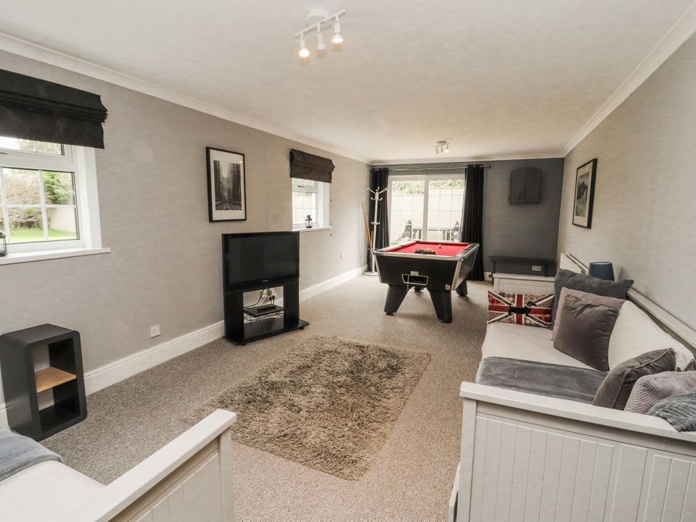 A snug with a pool table and sofa at White Gables in Great Clifton near Cockermouth
