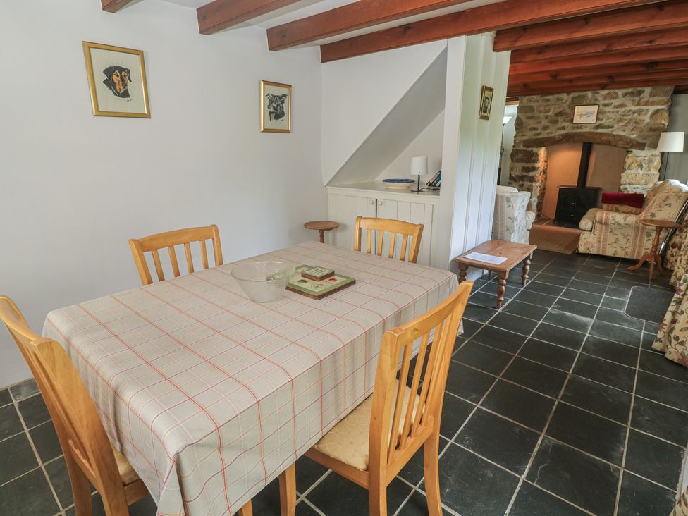 A dining room with a table and chairs at Longhouse, St Keverne, Lizard Peninsula