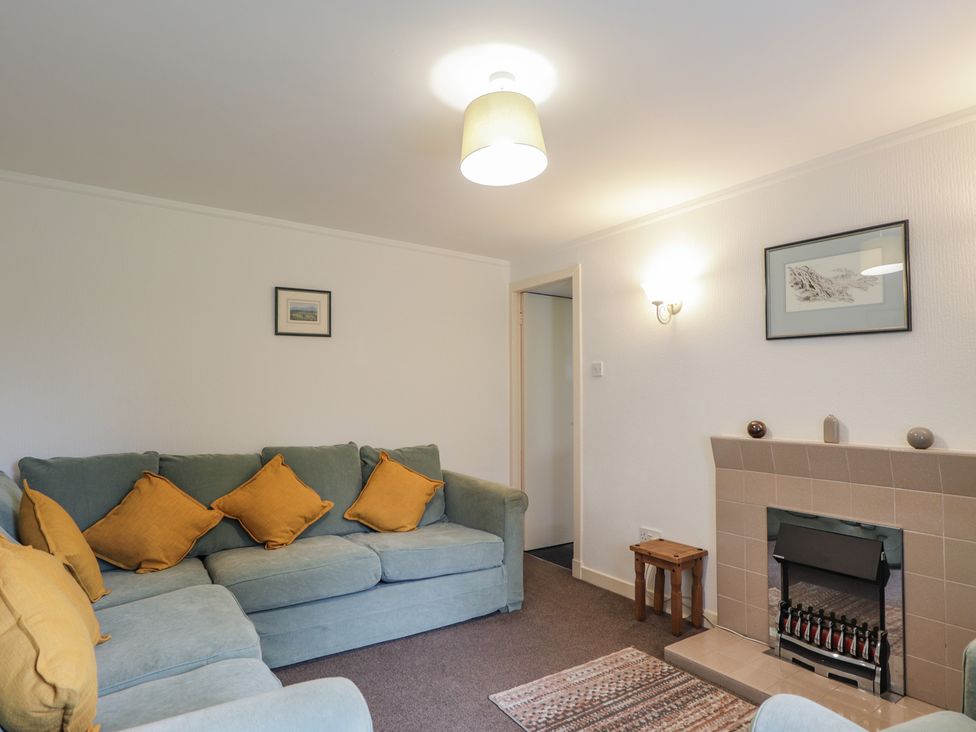 A living room with a sofa and fireplace at Lag-Uaine in Staffin