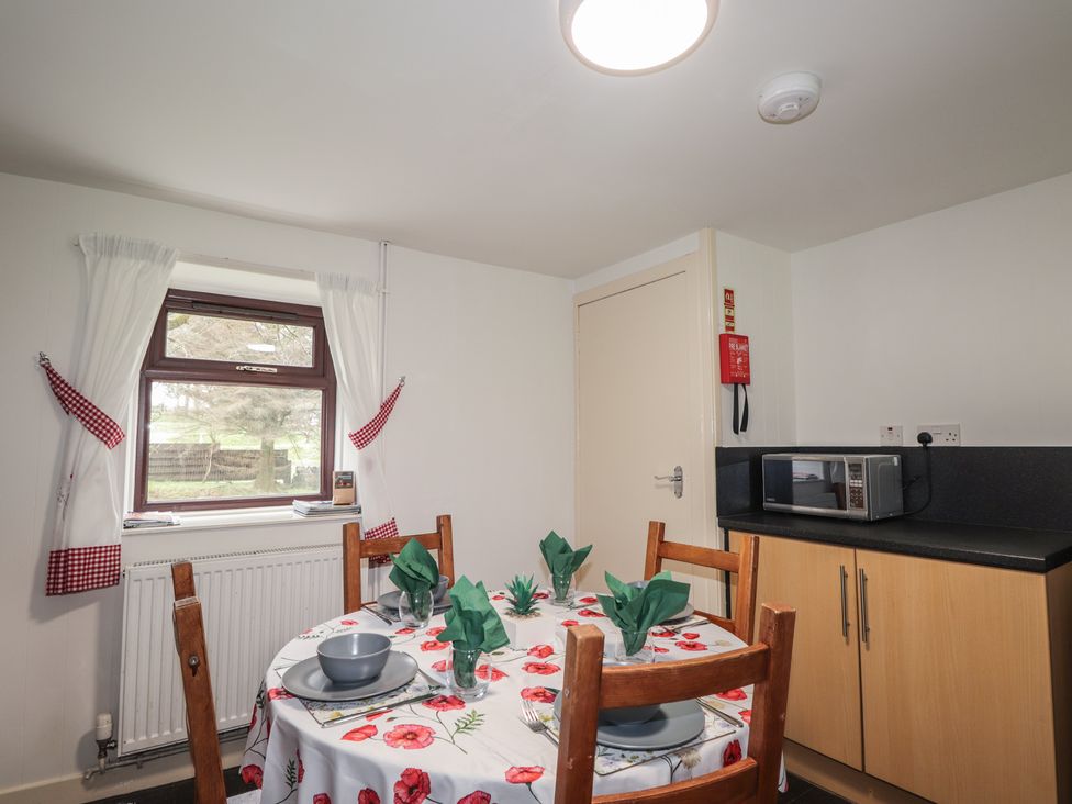 A kitchen with a table set for dining at Lag-Uaine in Staffin