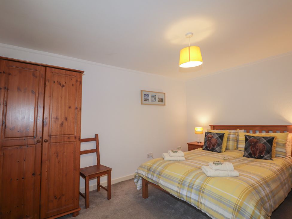 A bedroom with a bed and wardrobe at Lag-Uaine in Staffin