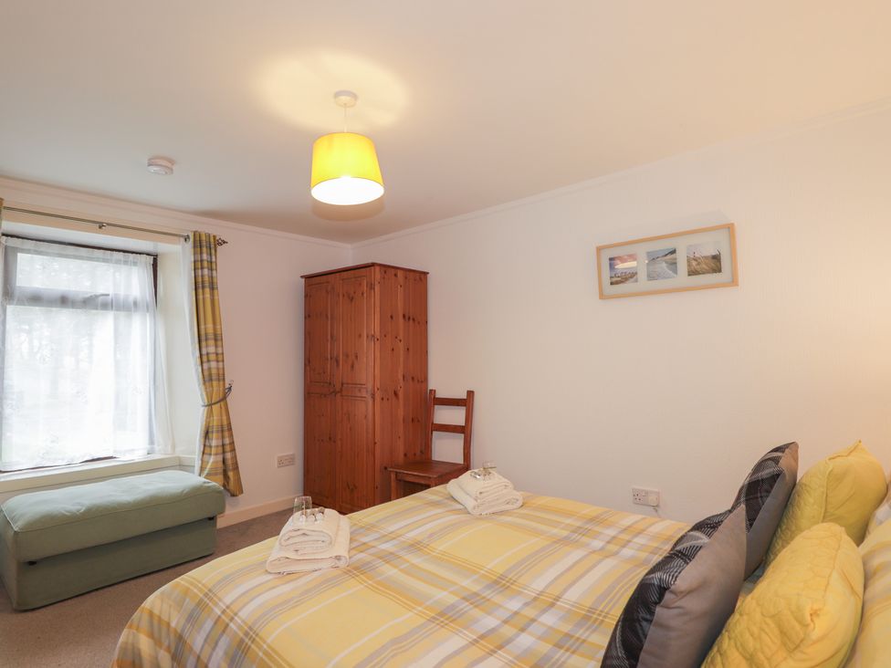 A bedroom with a bed and wardrobe at Lag-Uaine in Staffin