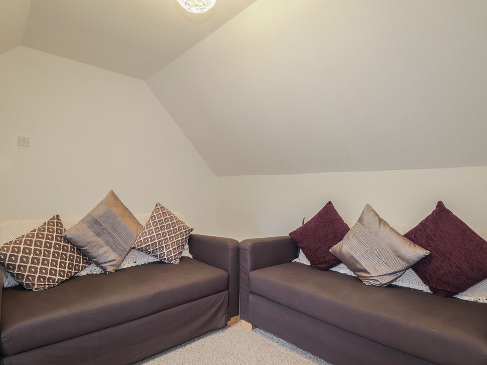 A snug with two sofas and cushions at Lag-Uaine in Staffin