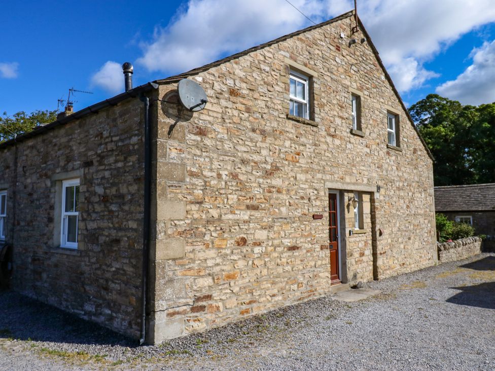 A stone house with a doorway and windows at Barnbrook in Carperby near Leyburn