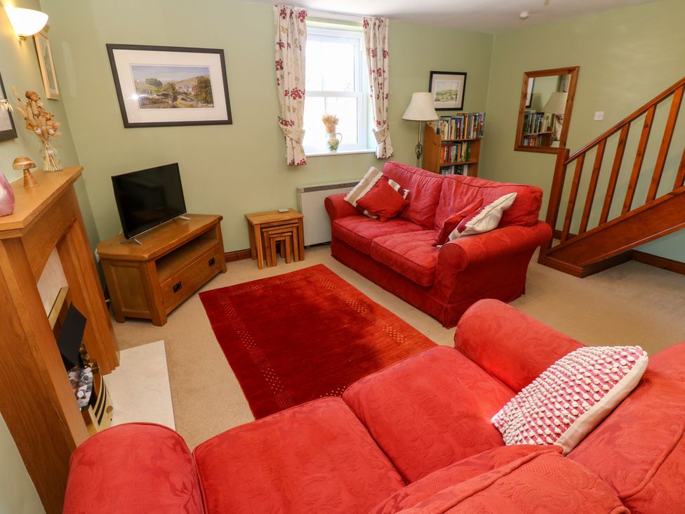A living room with a sofa and television at Barnbrook in Carperby near Leyburn