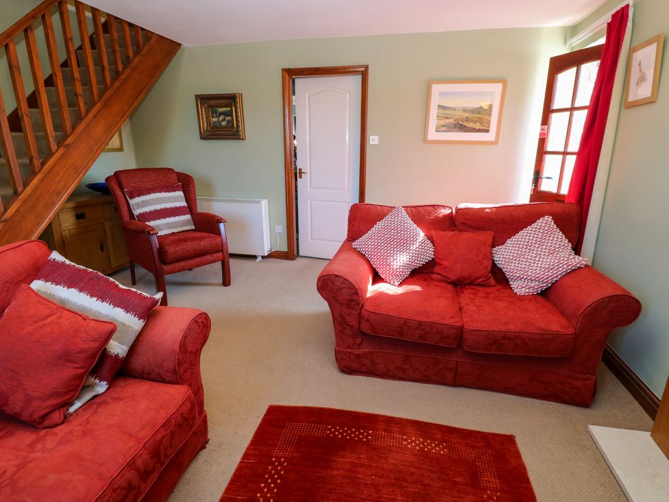 A living room with a sofa and armchair at Barnbrook in Carperby near Leyburn