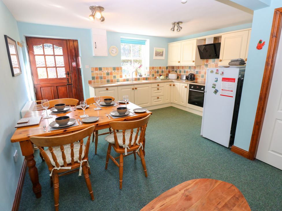 A kitchen with a table and chairs at Barnbrook in Carperby near Leyburn