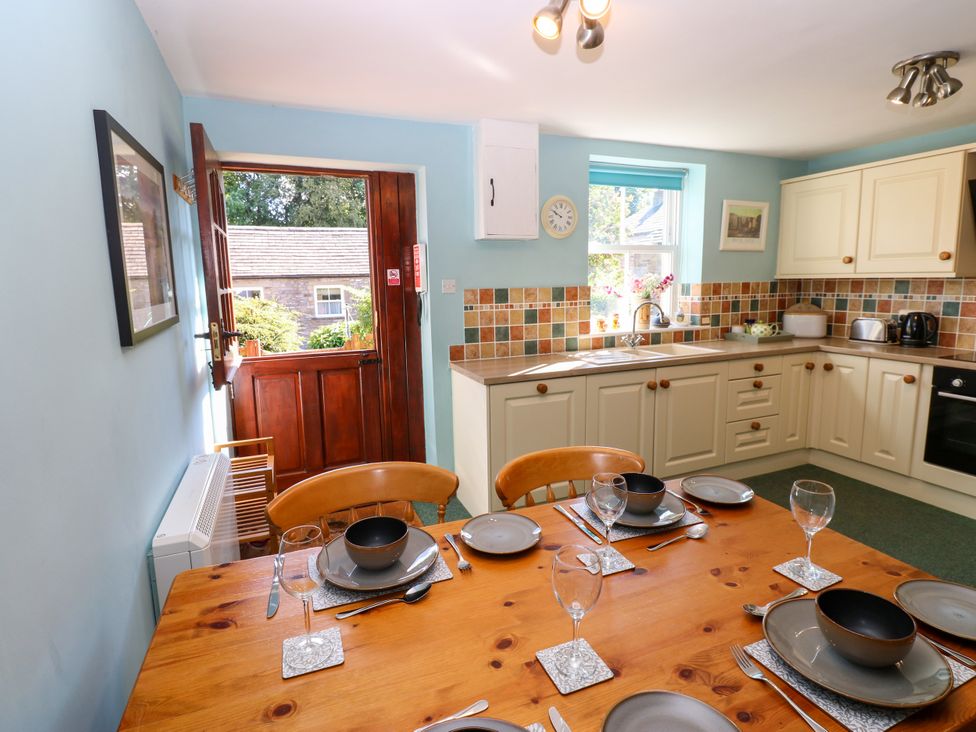A kitchen with a table set for dining at Barnbrook in Carperby near Leyburn
