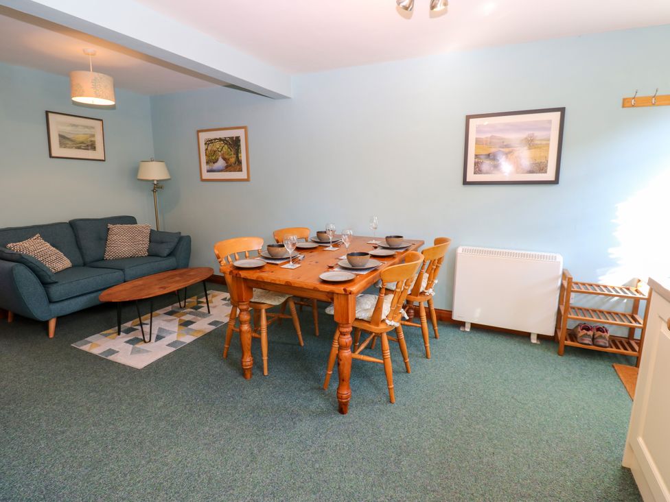 A dining room with a table and chairs at Barnbrook Carperby near Leyburn