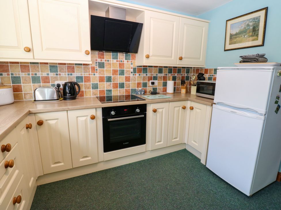 A kitchen with cabinets and appliances at Barnbrook in Carperby near Leyburn