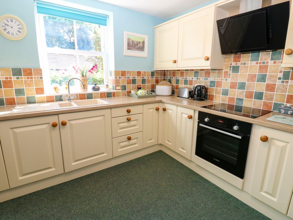A kitchen with a sink and cabinets at Barnbrook in Carperby near Leyburn