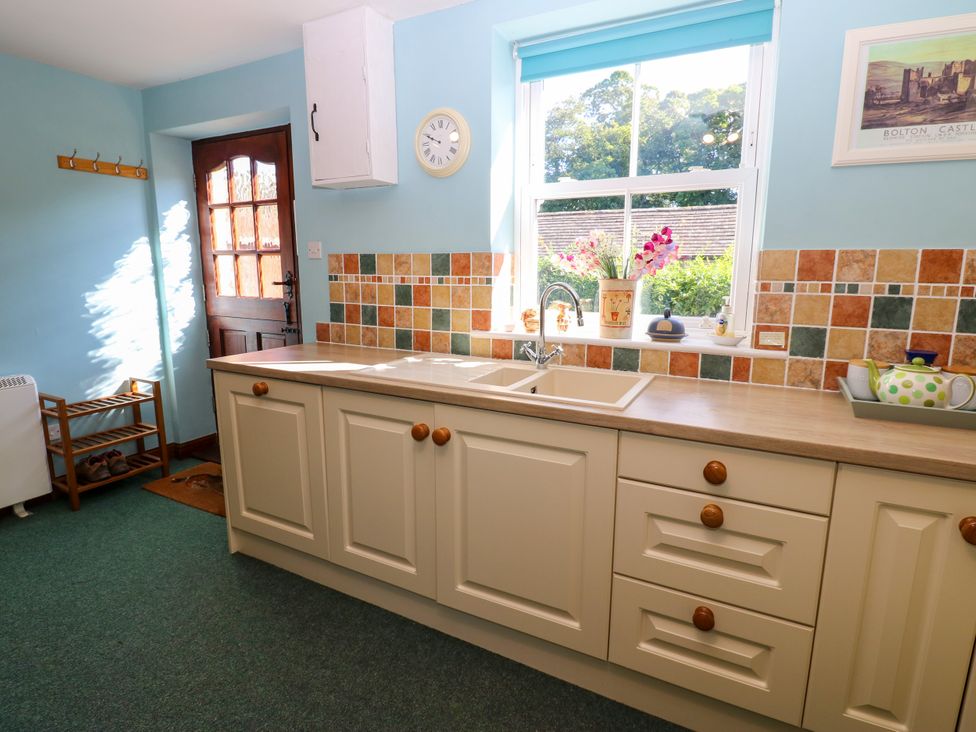 A kitchen with a sink and cabinets at Barnbrook in Carperby near Leyburn