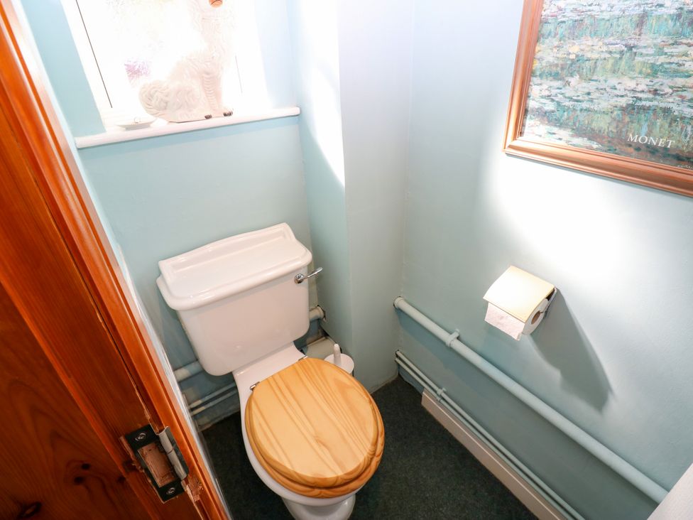 A bathroom with a toilet and a window at Barnbrook in Carperby near Leyburn