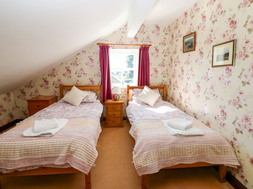 A bedroom with two beds and a window at Barnbrook Carperby near Leyburn