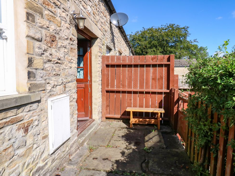 An outdoor area with a bench and fence at Barnbrook in Carperby near Leyburn