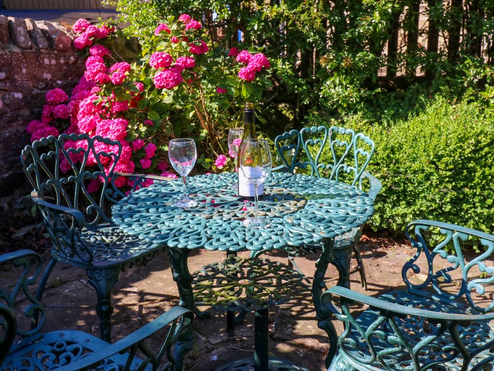 A table with chairs and wine glasses at Barnbrook in Carperby near Leyburn